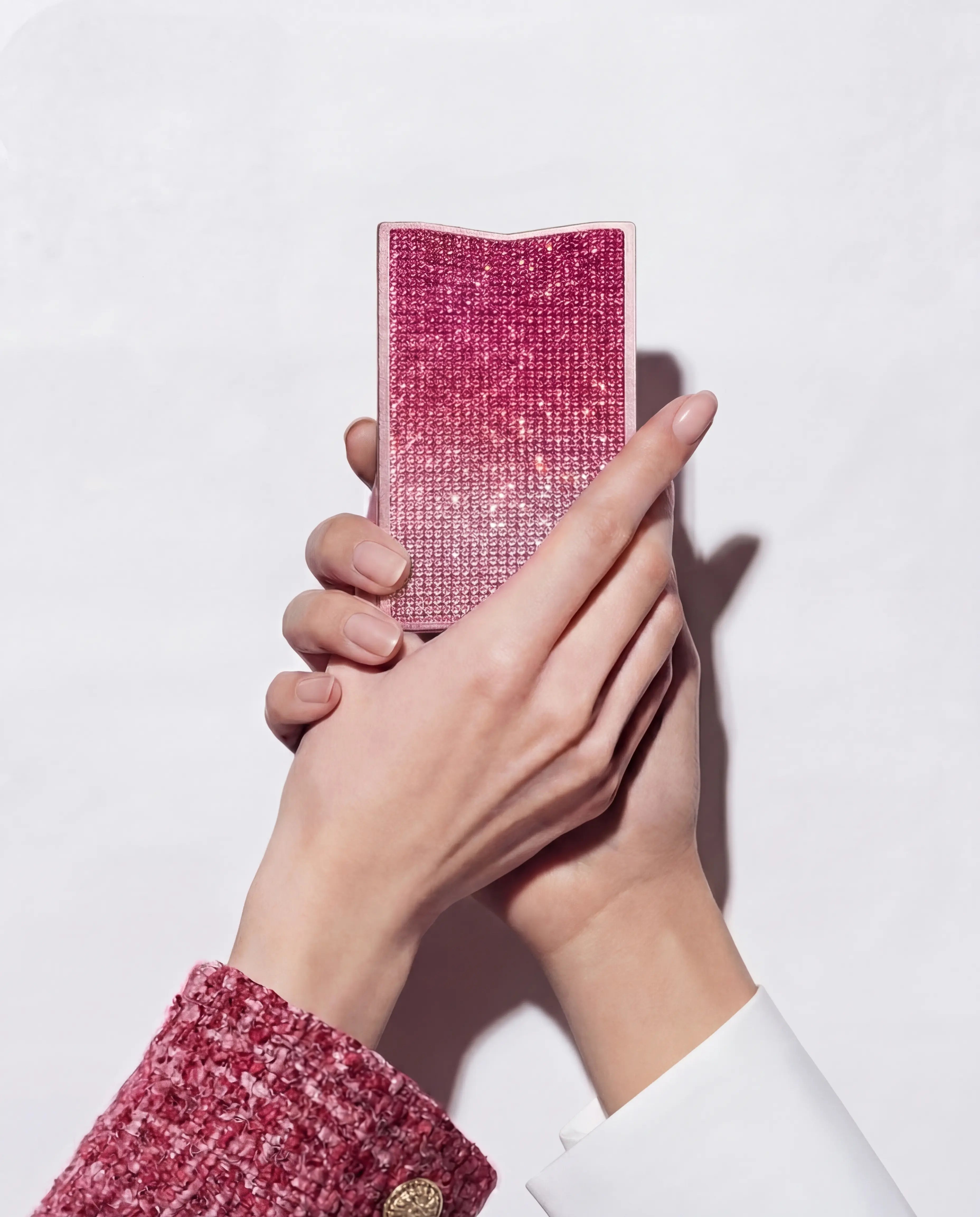 NETIC Crystal Wallet held in two hands, pink ombré crystals, slim compact cardholder, Italian leather, side profile view