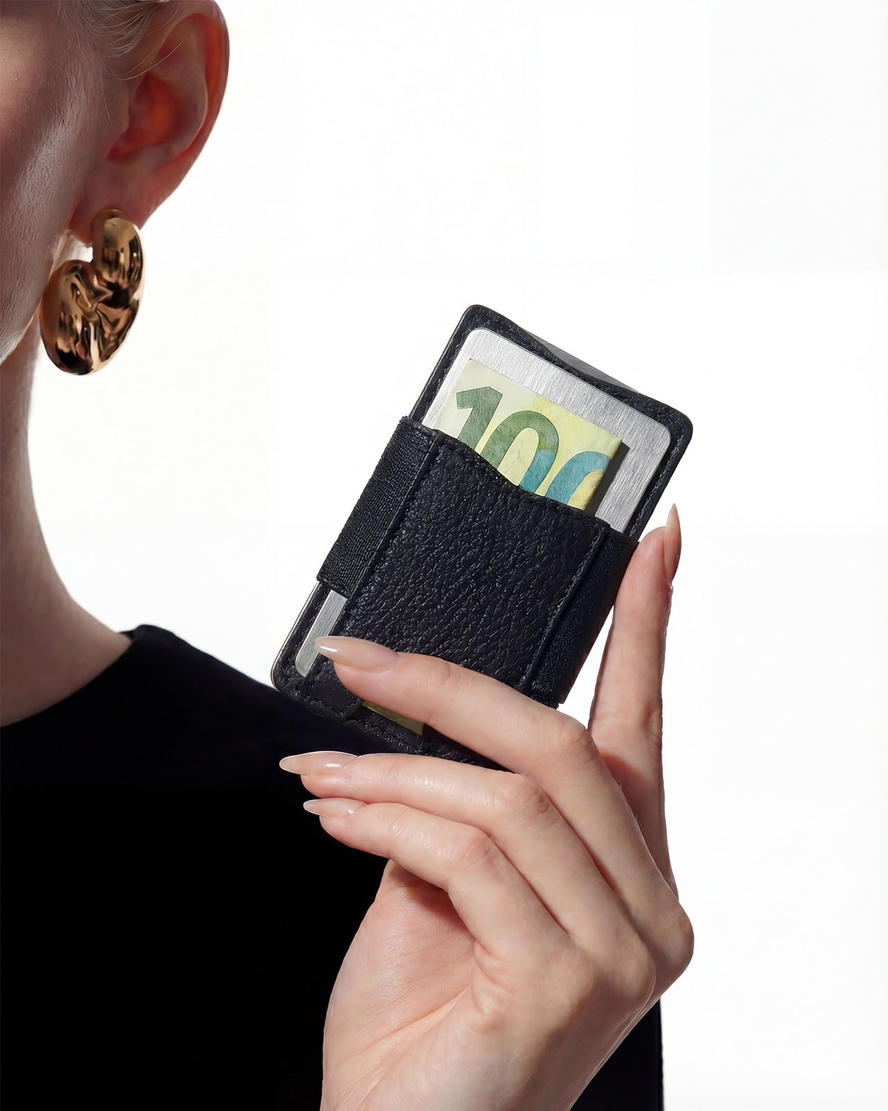 NETIC Couture Wallet black leather sleeve held by woman, banknote visible, slim luxury compact cardholder for women