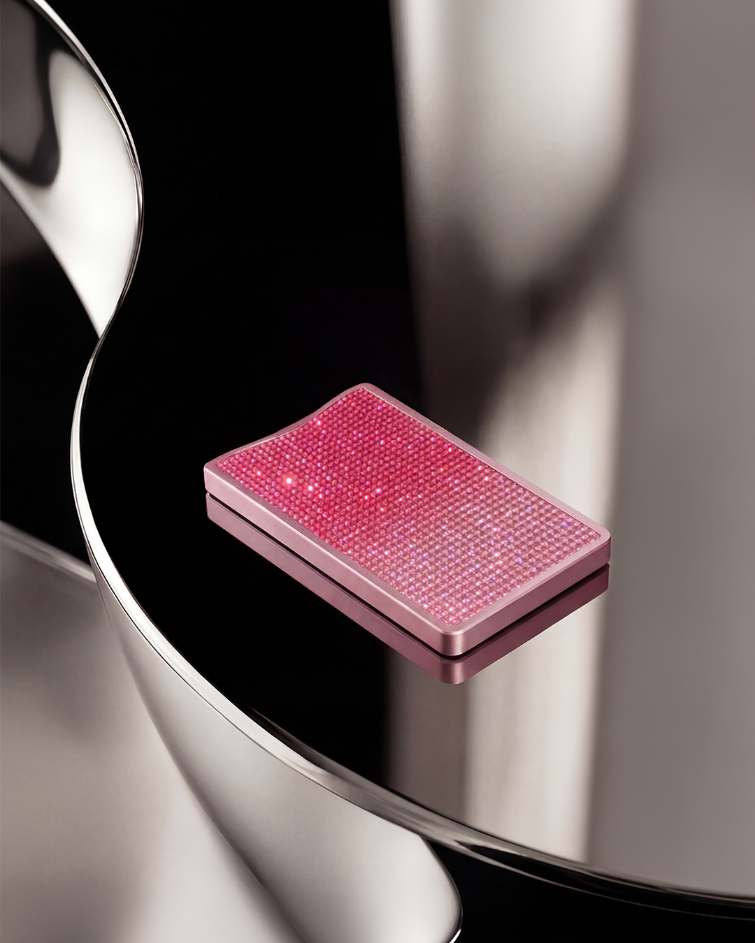 NETIC Crystal Wallet on chrome surface, pink ombré glass crystals, luxury compact cardholder, Italian leather