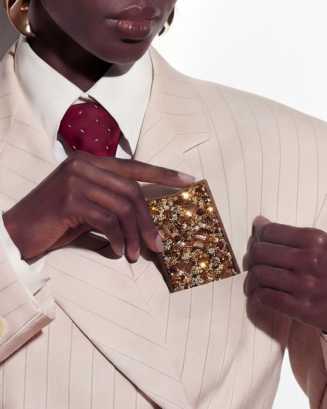 NETIC Couture Wallet held by woman in ivory suit, gold and topaz crystals, luxury compact cardholder, limited to 99 pieces