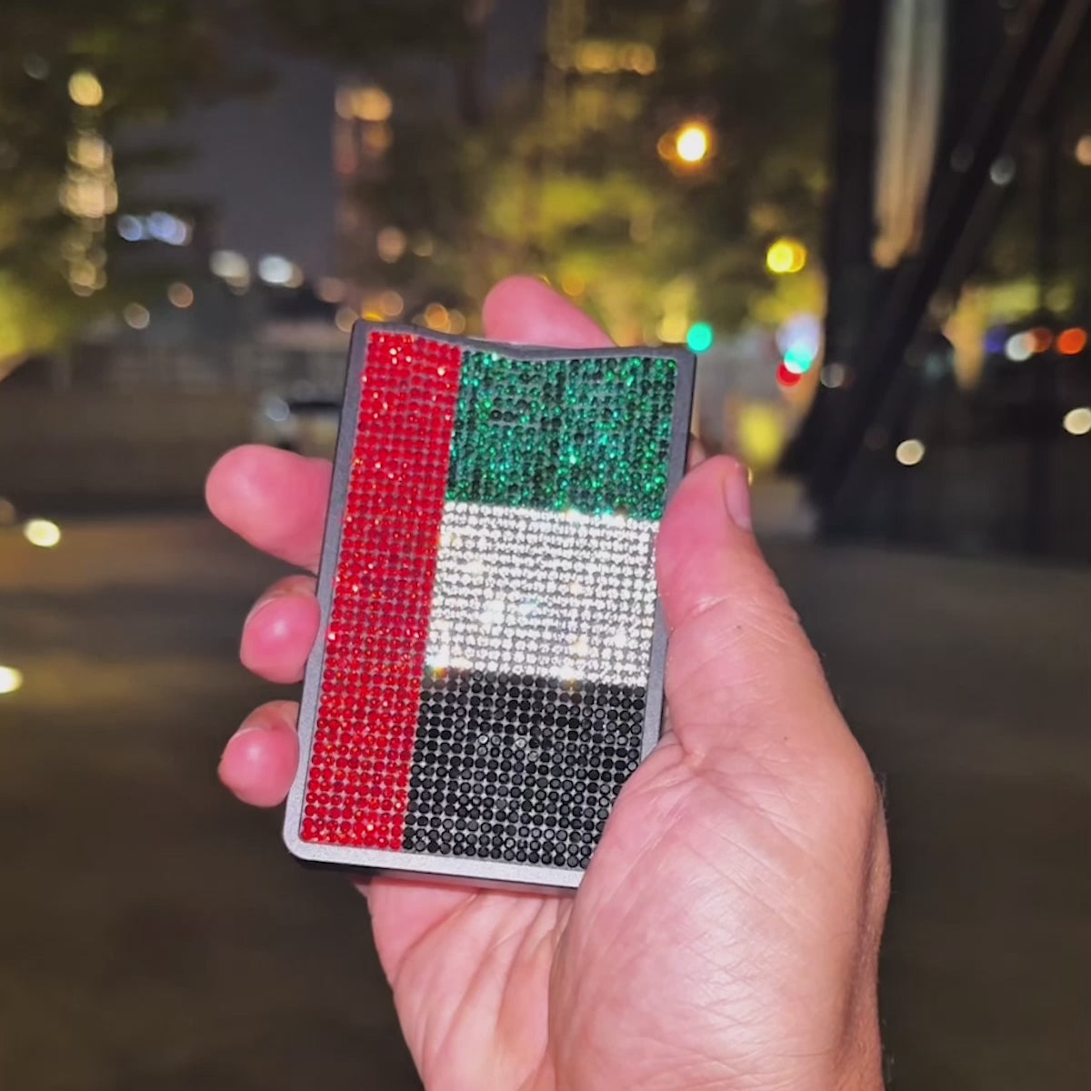 NETIC Crystal Wallet Proud UAE Edition in use — the 3:3 Pop mechanism releasing six cards